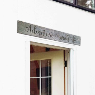 Adventure Awaits sign on top of door