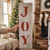 Holding a Joy Christmas Sign